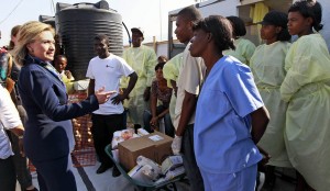 Secretary of State Hillary Rodham Clinton talks with workers as she visits Partners in Health Cholera Treatment Center in Port-au-Prince, Haiti, Sunday, Jan. 30, 2011. (AP Photo/Alex Brandon, Pool)